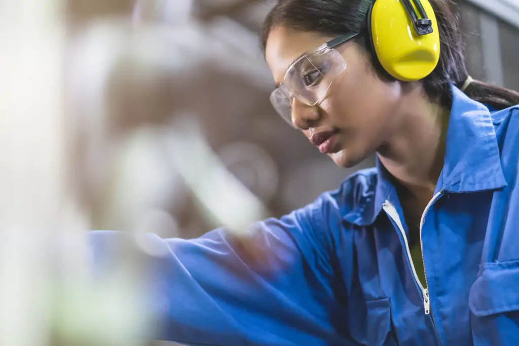 Women wearing safety goggles while working with the glass