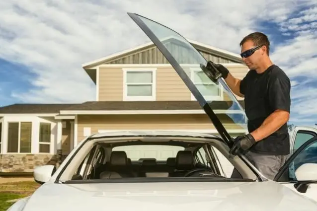 Handsome technician installing a new windshield