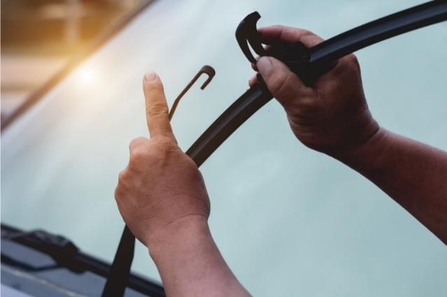 Man is changing wiper blades with J Clip fitting system