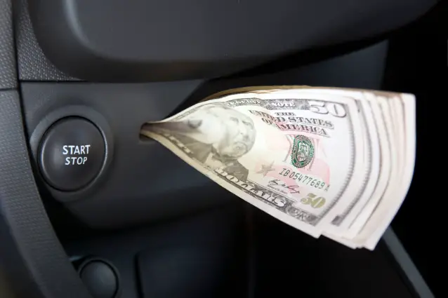 Money inside the car's visit card holder, right behind start button