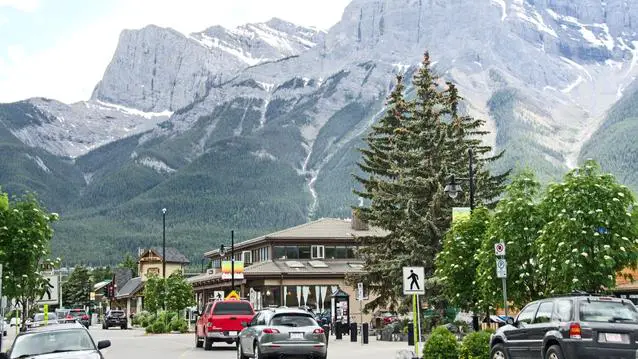Beautiful view of the street in Banff, Alberta, Bright day and mountains on background.
